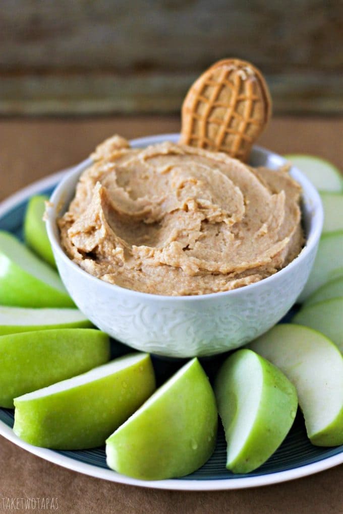 The classic Nutter Butter cookie gets a makeover with some cream cheese! Spread it on some tart apples for the perfect afternoon snack! Don't like apples? Grab your favorite thing to pair with peanut butter and dig in! Nutter Butter Dip with Apples Recipe| Take Two Tapas