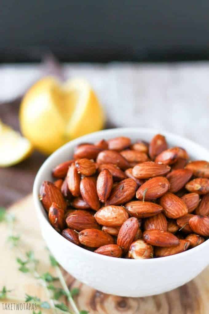 Close up of almonds with lemon thyme in a bowl