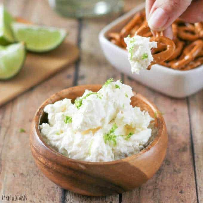 Close up of Hand dipping a pretzel in to the Margarita dip