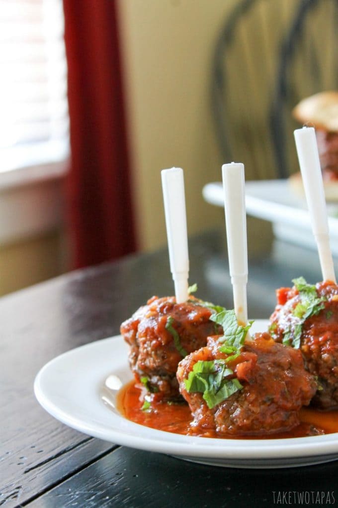 Meatballs aren't just Italian food anymore! These meatballs are made with lamb, Greek seasoning, and cilantro. Cooked in a fresh tomato sauce they are the perfect tapas dish, main course, or party appetizer. Mediterranean Lamb Meatballs Recipe | Take Two Tapas | #Mediterranean #lamb #meatballs #tapas #TomatoSauce