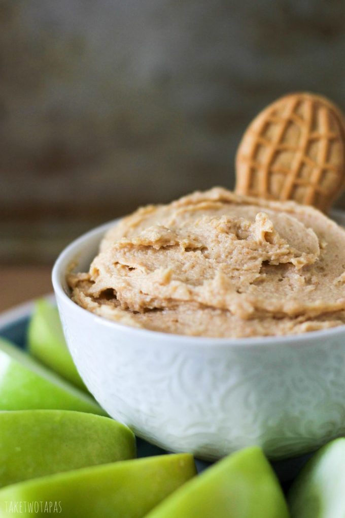 The classic Nutter Butter cookie gets a makeover with some cream cheese! Spread it on some tart apples for the perfect afternoon snack! Don't like apples? Grab your favorite thing to pair with peanut butter and dig in! Nutter Butter Dip with Apples Recipe| Take Two Tapas | #NutterButter #PeanutButter #Apples #Dip #SweetDip #Snack #Cookies