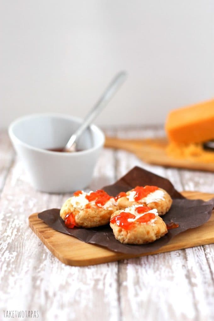 Who knew that cookies could be savory? I did! These cheesy, flaky cookies are full of flavor and spice and with creamy goat cheese on top with a sweet and spicy pepper jelly, they are the perfect bite! Spicy Cheese Thumbprints with Goat Cheese and Hot Pepper Jelly Recipe | Take Two Tapas | #Cookies #Thumbprints #Spicy #CheeseCrackers #HotPepperJelly #GoatCheese