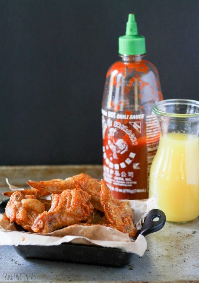 You can't always find Paleo-friendly foods at a tailgate party, so make these Sriracha Pineapple wings and be the hero! Keep with your Paleo goals and chow down on some sweet and spicy wings! Sriracha Pineapple Chicken Wing Recipe | Take Two Tapas | #Sriracha #Pineapple #ChickenWings #chicken #tailgate #MarchMadness