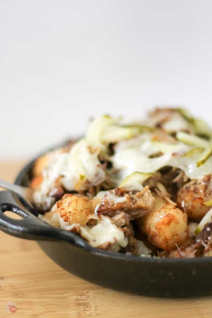 Side view of Cuban Totchos nachos in a cast iron pan