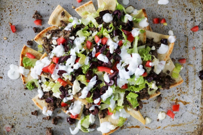 Love to grab a Gyro sandwich on the run? All the flavors of a Gyro but in the form of Nachos. Greek flavors like cucumber, dill, lamb, and Kalamata olives. Gyro Nachos with Pita Chips Recipe | Take Two Tapas