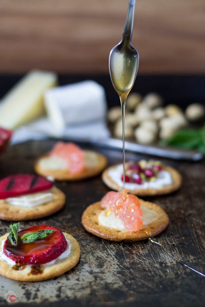 Serving cheese and crackers at your next summer party? Try grilling your crackers for a unique twist. Melt your cheese and add other grilled toppings too! Grilled Crackers for Summer Entertaining Recipe | Take Two Tapas