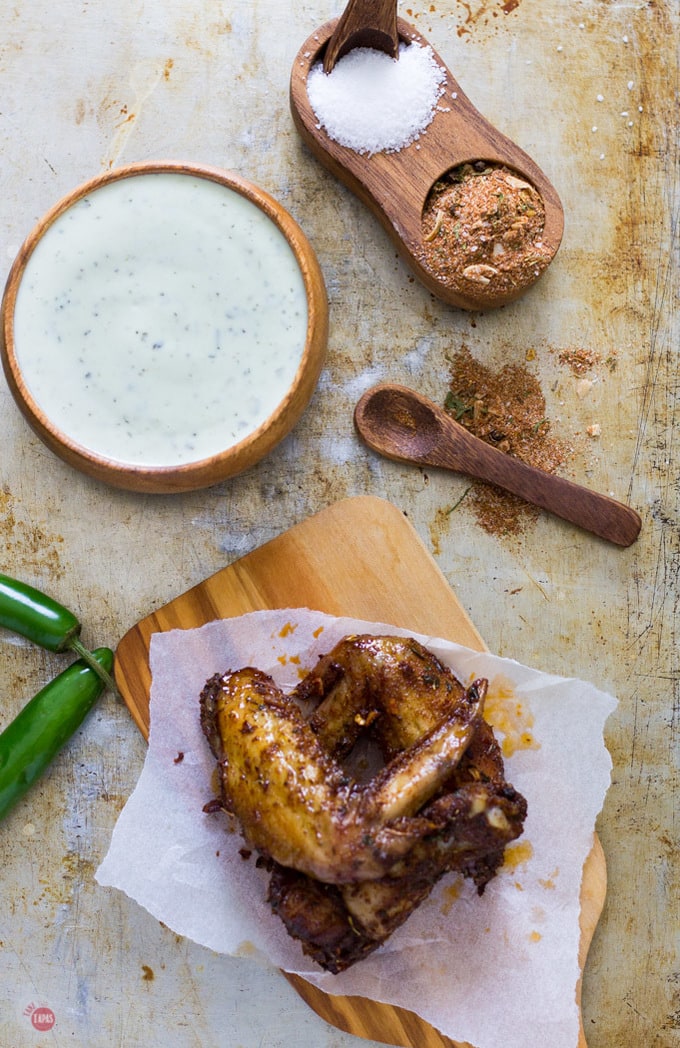 Overhead of Jerk seasoned chicken wings on a cutting board