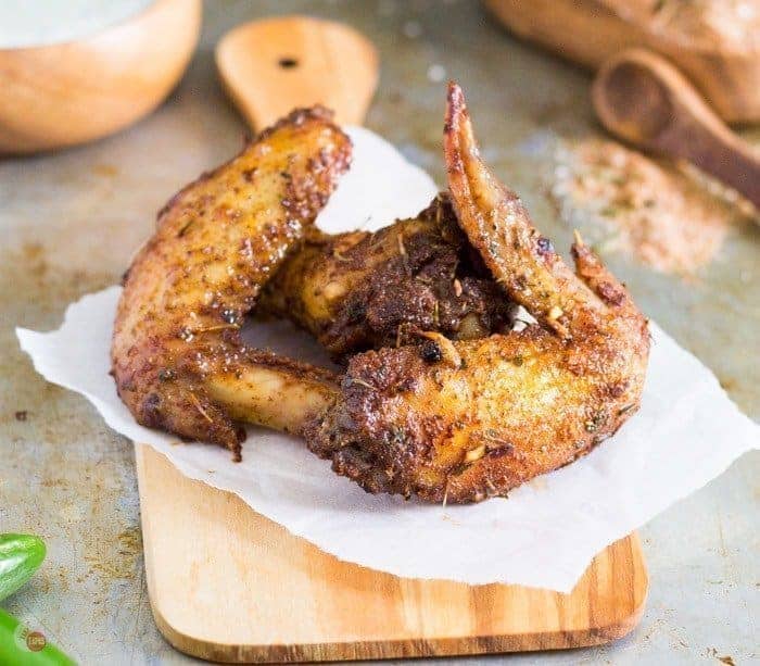 Close up of Jerk seasoned chicken wings on a cutting board