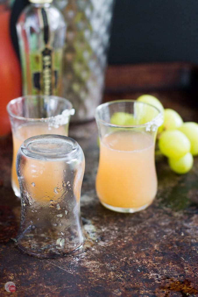 This flavorful shot will remind you of a salty dog cocktail but with the flavors of green grapes and much smaller! | Take Two Tapas | #GreenGrapes #SaltyDog #CocktailShots #Vodka #PinkSalt #SaltyDogShot