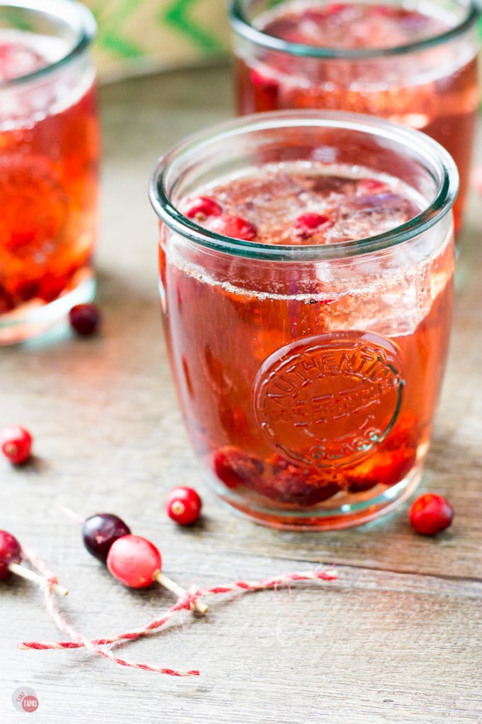 Roasted cranberries pair nicely with tart cranberry juice, caramel hinted bourbon, and bubbly lemon-lime soda. Perfect a large batch of punch! Roasted Cranberry Bourbon Crush Recipe | Take Two Tapas