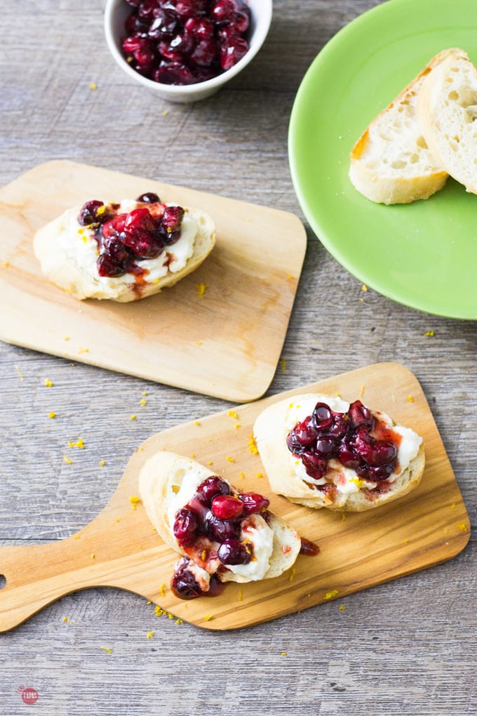 Drizzle roasted cranberries on a crispy baguette and you'll have a festive crostini appetizer for any party! | Take Two Tapas | Roasted Cranberry Ricotta Crostini Recipe | Take Two Tapas | 