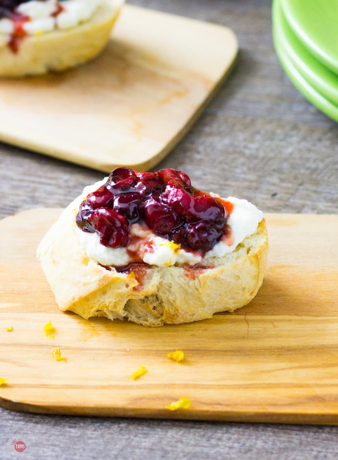 Get in the holiday spirit with some honey roasted cranberries. Drizzle these on top of a creamy bed of orange flecked ricotta cheese on a crispy baguette and you'll have a festive crostini appetizer for any party! Roasted Cranberry Ricotta Crostini Recipe | Take Two Tapas