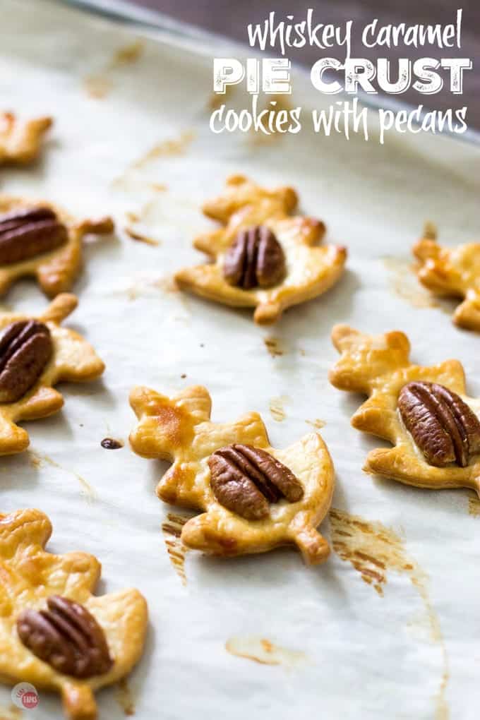 Simple and flaky pie crust is transformed into easy pie crust cookies topped with a pecan and drizzled with a whiskey caramel sauce! Cut them into your favorite shape to fit your holiday or occasion. Whiskey Caramel Pie Crust Cookies Recipe | Take Two Tapas | #Whiskey #Caramel #PieCrust #Cookies #PieCrustCookies #WhiskeyCaramel #CookieRecipe