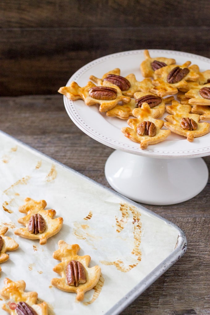 Simple and flaky pie crust is transformed into easy pie crust cookies topped with a pecan and drizzled with a whiskey caramel sauce! | Take Two Tapas | #Whiskey #Caramel #PieCrust #Cookies #PieCrustCookies #WhiskeyCaramel #CookieRecipe