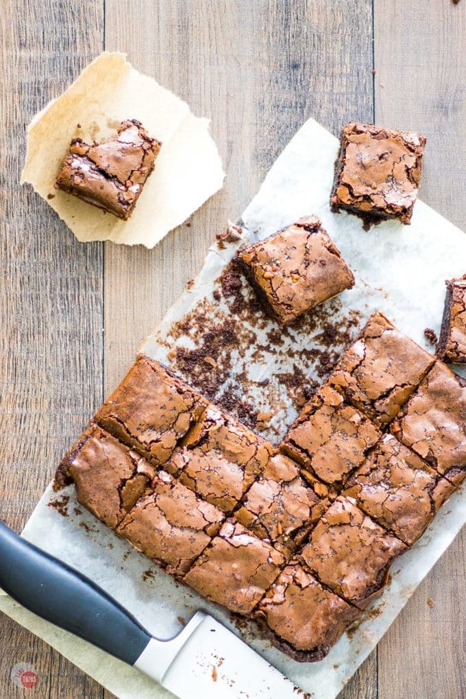 Overhead of Bacon Salt Brownies on parchment paper on a wood surface