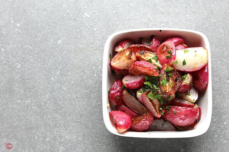 **Shake up your side dish options with Crispy Garlic Radishes. Usually a bit on the pungent side, radishes become sweet when roasted. The addition of olive oil and garlic make them a great way to add new vegetables to your dinner plate! Crispy Garlic Radishes Recipes | Take Two Tapas | Crispy #Garlic #Radish #Radishes #Spring #SideDish #Paleo