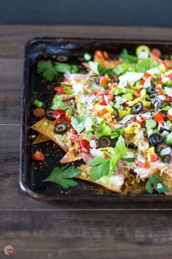 Italian sheet pan nachos on a wood surface