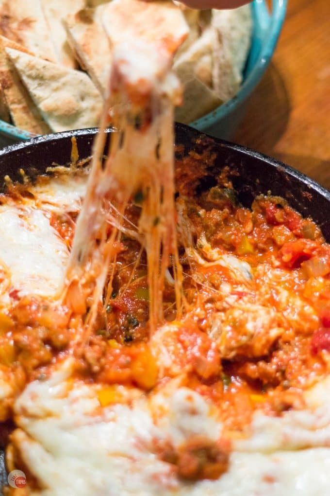 Slow simmered arrabbiata sauce mixed with sausage and veggies and topped with cheese makes the perfect dip to share with friends! Arrabbiata Skillet Sausage Dip with Pizza Chips Recipe | Take Two Tapas