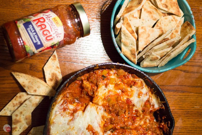 Slow simmered arrabbiata sauce mixed with sausage and veggies and topped with cheese makes the perfect dip to share with friends! Arrabbiata Skillet Sausage Dip with Pizza Chips Recipe | Take Two Tapas