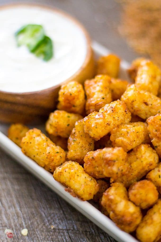 Warm and spicy steakhouse tater tots have the right amount of kick with my homemade steak seasoning. Take them for a cool dip in jalapeno ranch for an awesome snack! Perfect for the big game or any tater tot craving! Steakhouse Tater Tots with Jalapeno Ranch Dip | Take Two Tapas