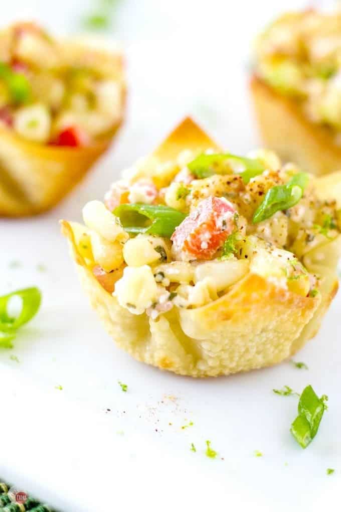 These Mexican Street Corn Salad Wonton Cups are the bomb! Roasted corn combined with jalapeno, red onions, sour cream, Cojita cheese, and some chili powder for spice makes a great party appetizer or side dish. Mexican Street Corn Salad Wonton Cups Recipe | Take Two Tapas