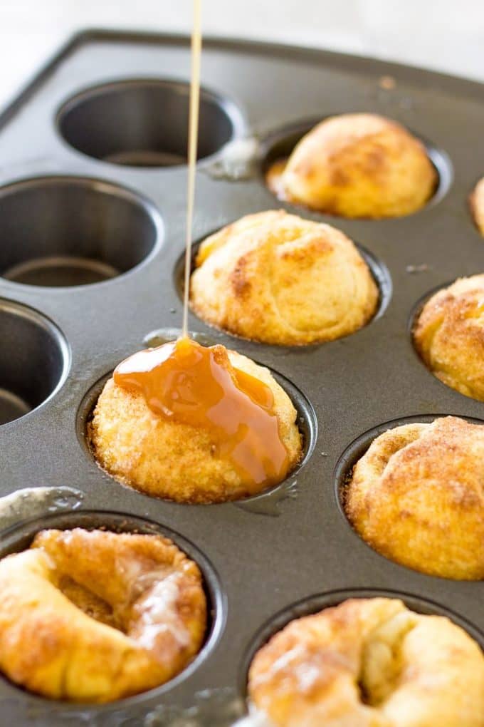 drizzling bourbon caramel sauce on the marshmallow bombs