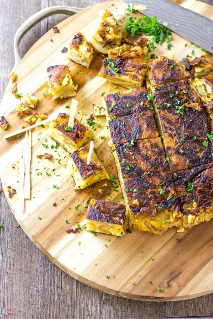 overhead of Tortilla Espanola with Pimento Cheese on a wooden cutting board