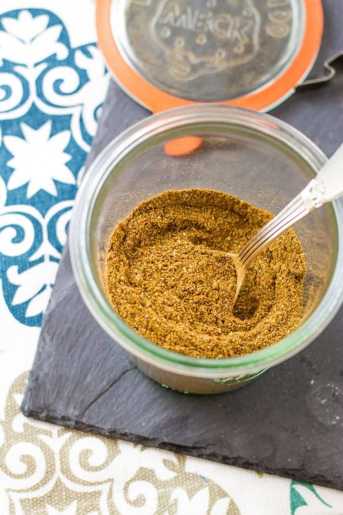 Overhead of seasoning in a jar with a spoon in it