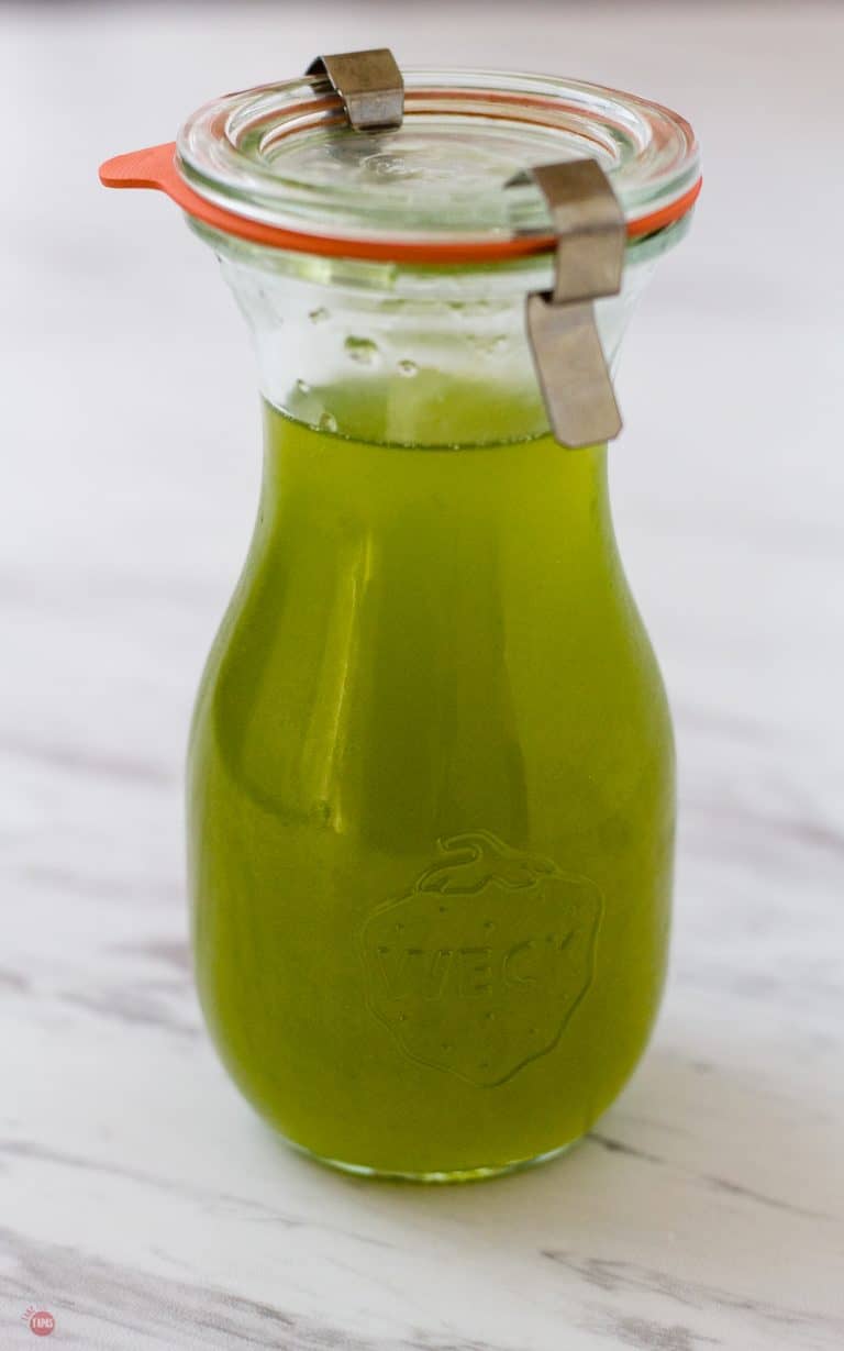 Close up of Chili Pepper Simple Syrup in a sealed carafe