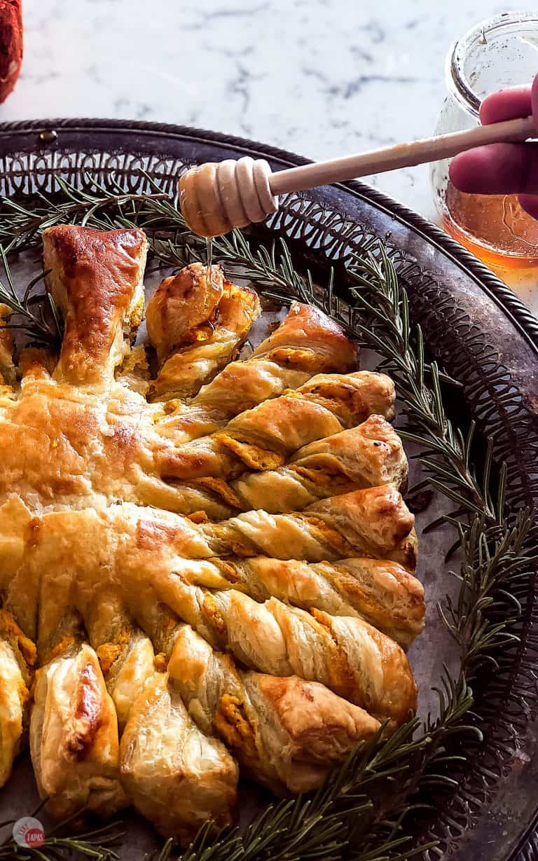 Honey being drizzled on Easy Golden Brown and Flaky Pumpkin Pull Apart Puff Pastry