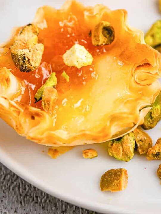 https://www.taketwotapas.com/wp-content/uploads/2020/12/apricot-pistachio-brie-phyllo-cups-recipe-card-540x720.jpg