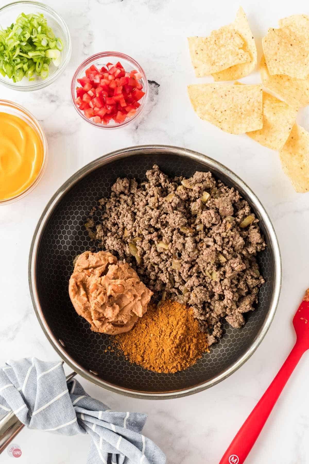 ground beef and refried beans in a pan