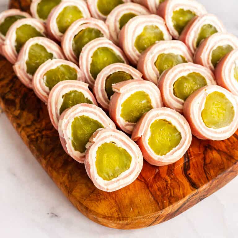 wood platter of pickle roll ups