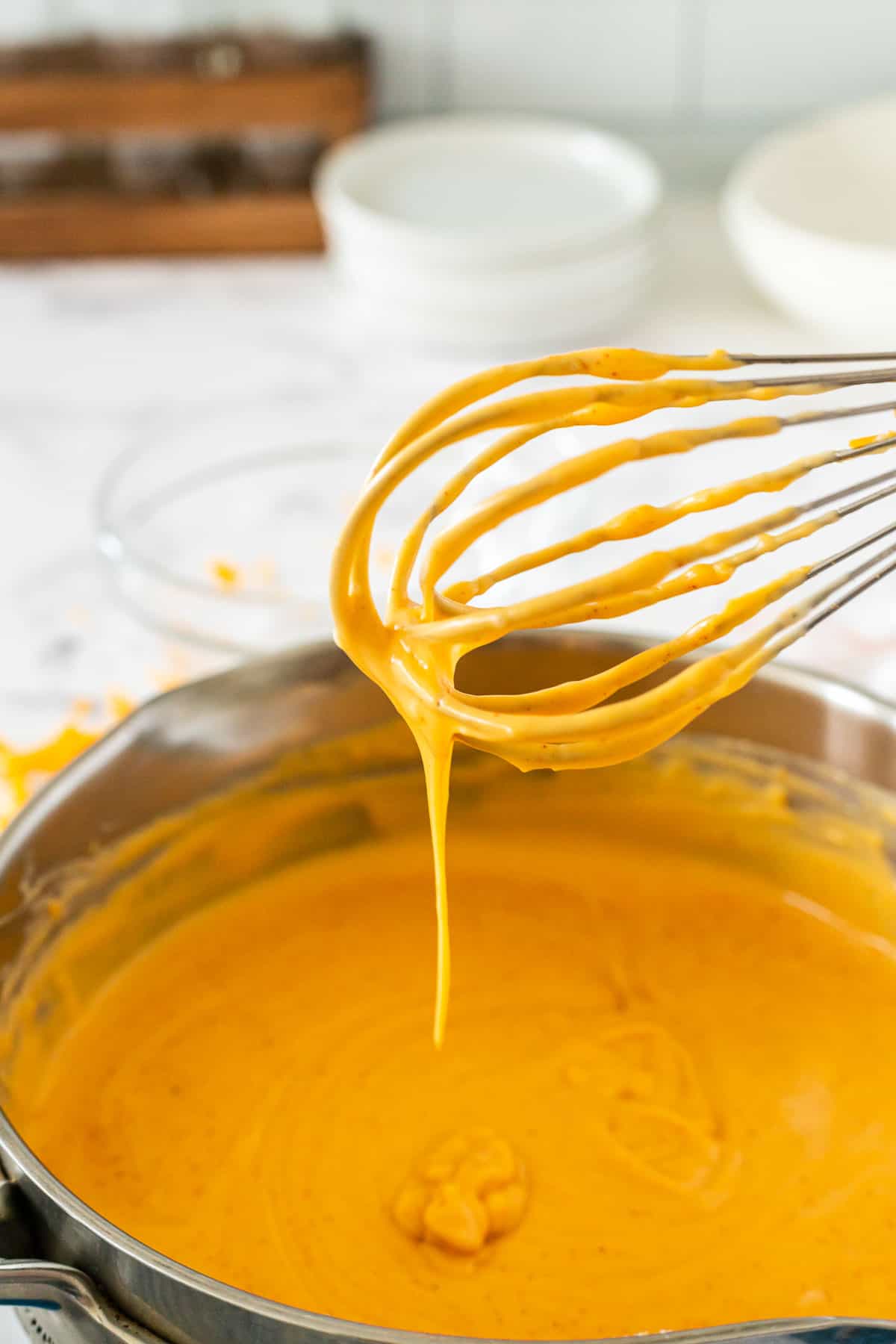 whisk with cheese sauce