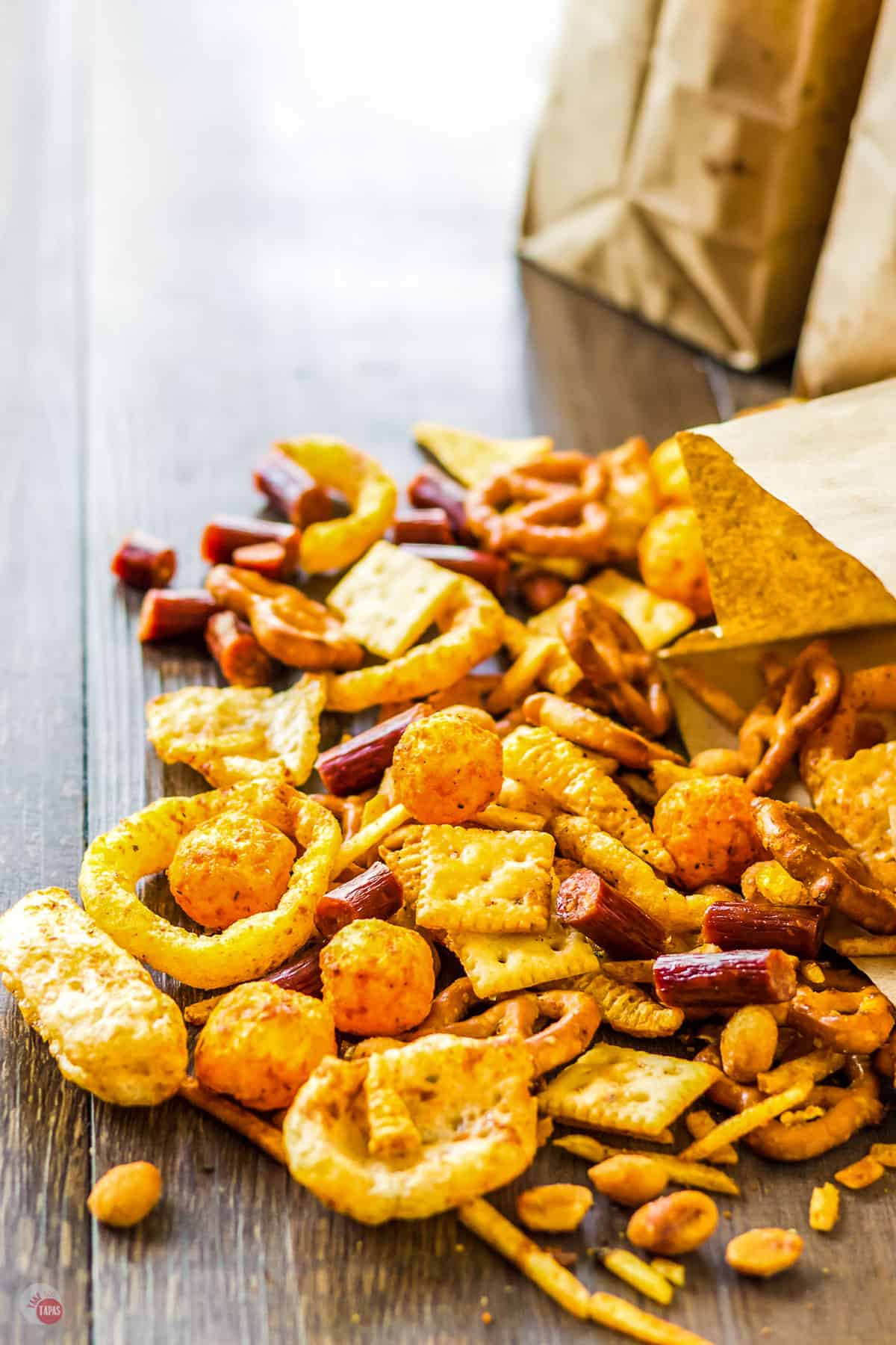 bar snack mix falling out of a brown paper bag