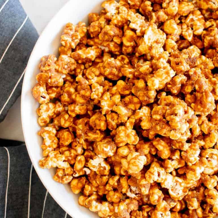 close up of bowl of caramel corn with blue napkin