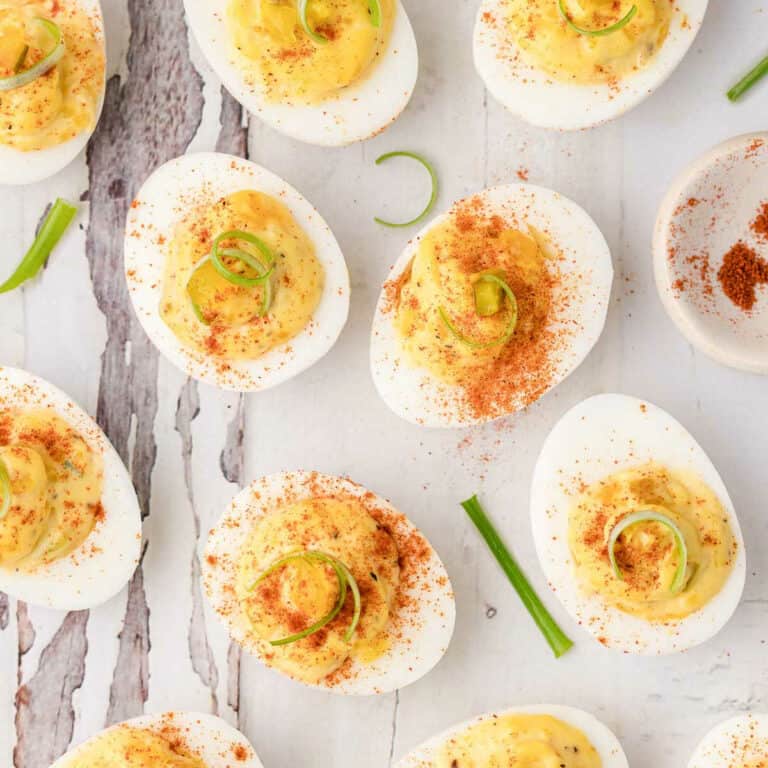 wood plank with deviled eggs on it