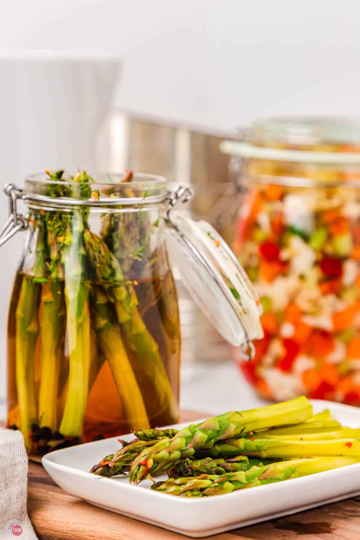 pickled asparagus on a white tray