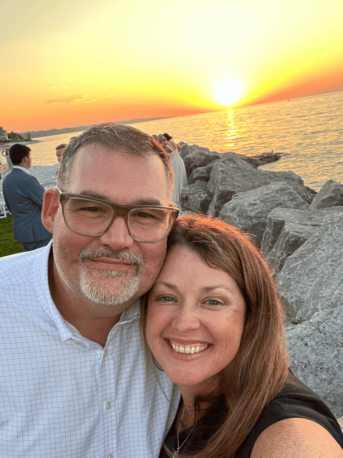 Jennifer and Brooks in front of a sunset