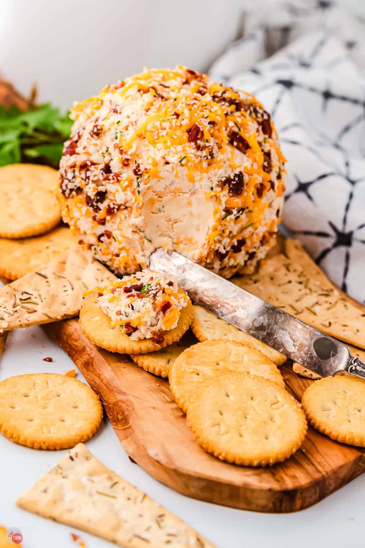 knife cutting into a cheese ball