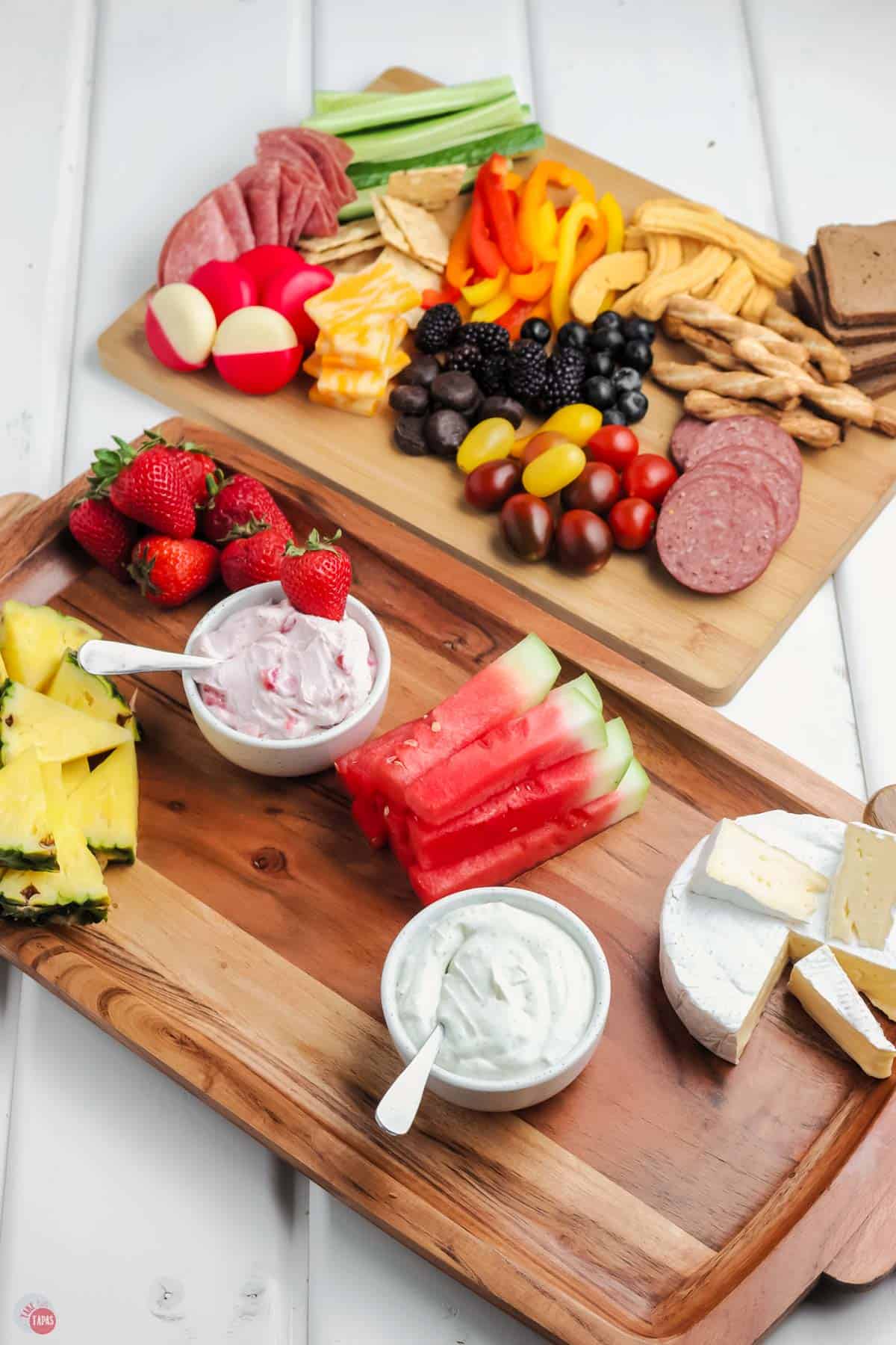 cheese and yummy snacks on a wood board