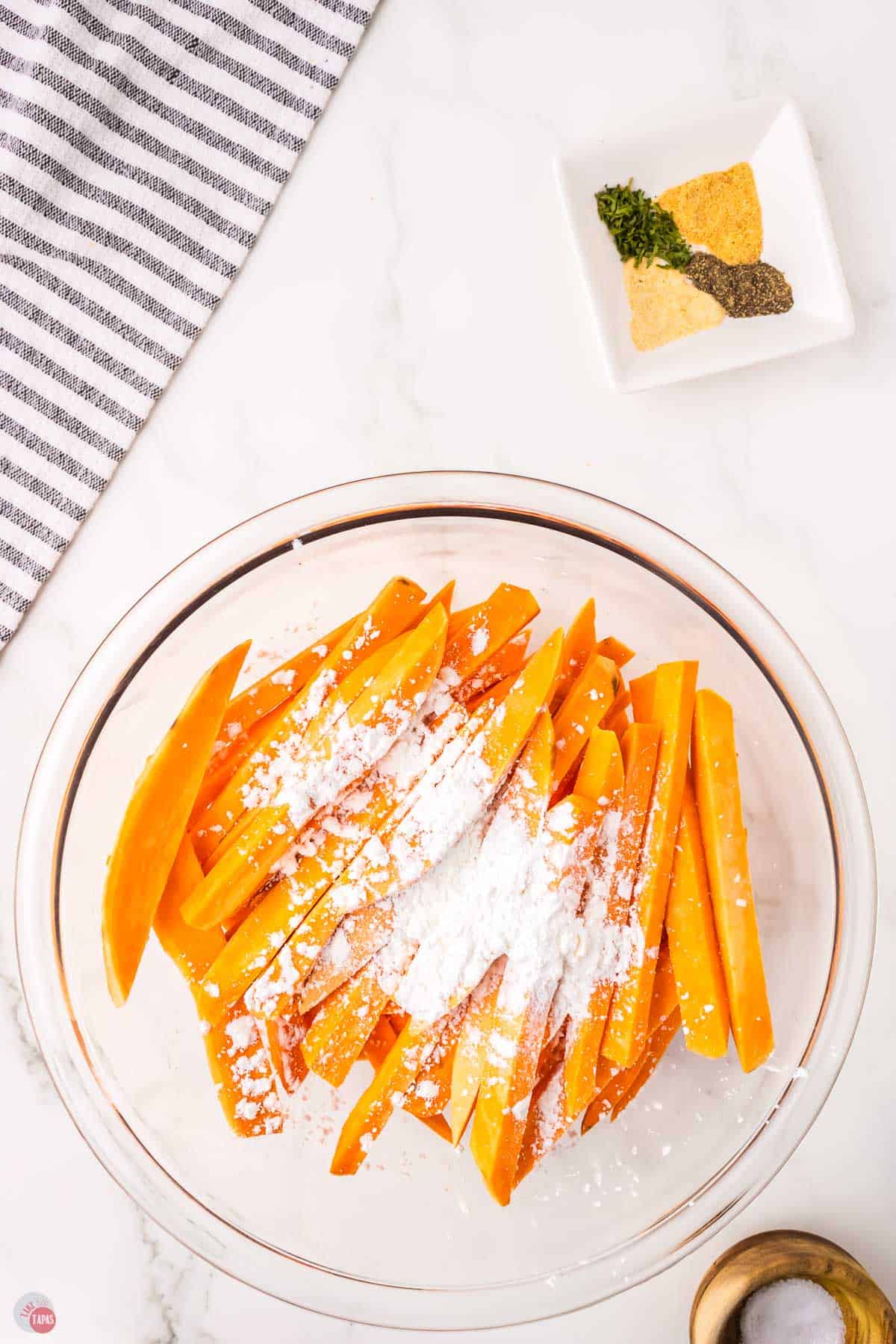 sweet potato strips in a bowl with cornstarch