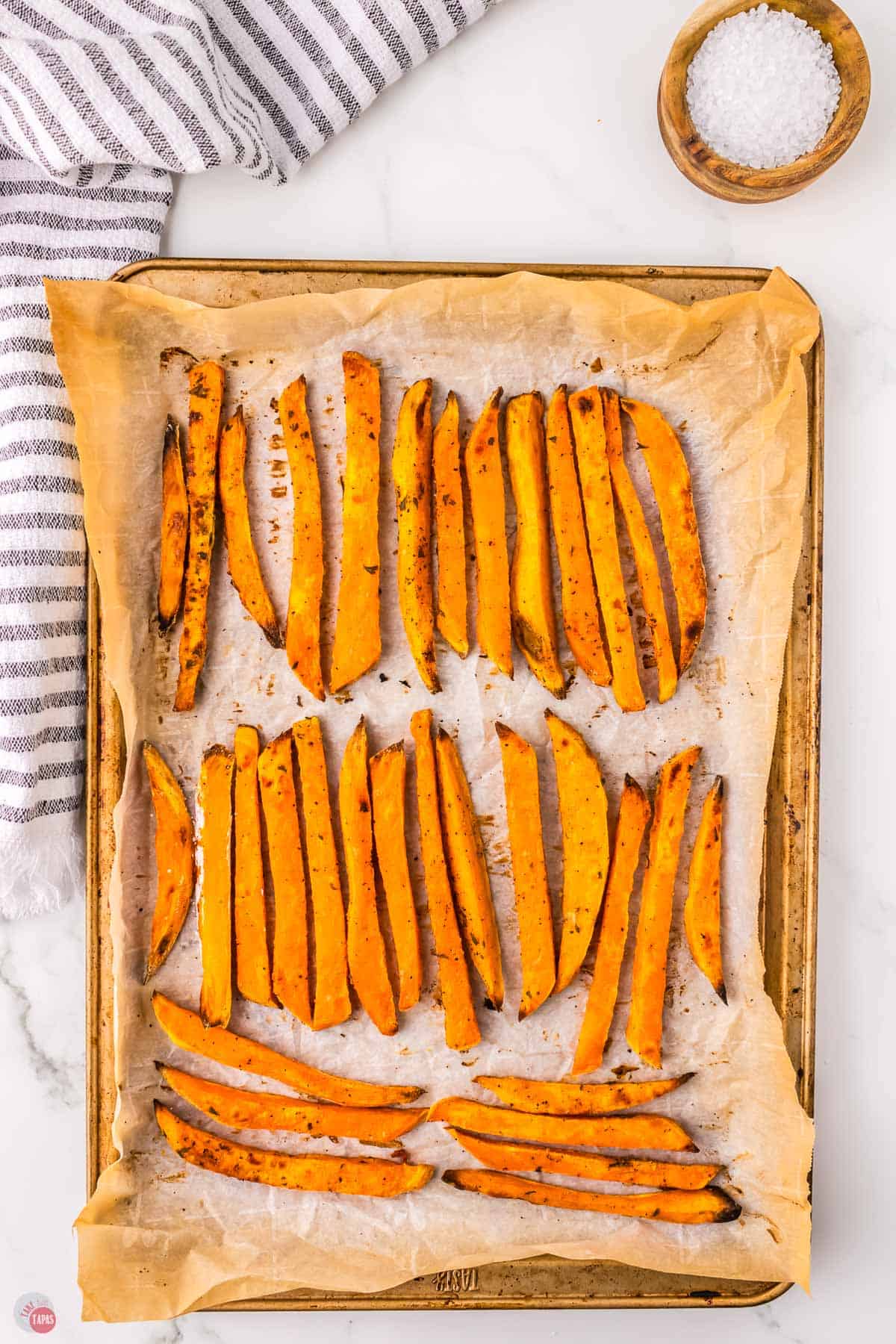 baking sheet with parchment and fries