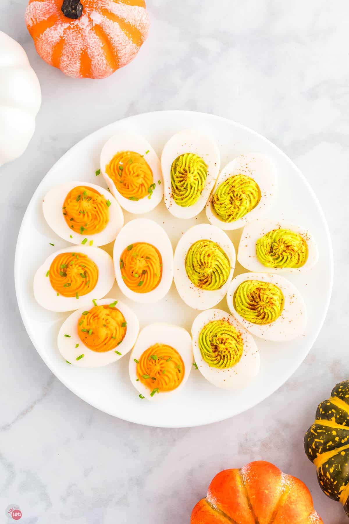 plate of Halloween deviled eggs with chives and paprika