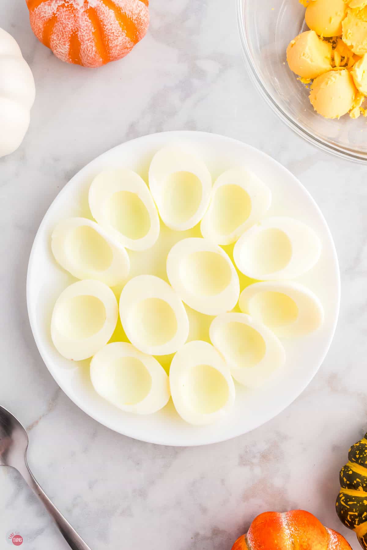 egg halves on a plate with the yolks removed