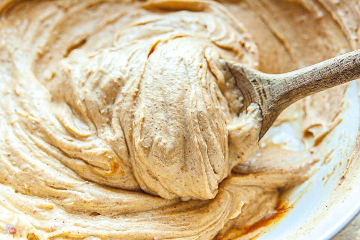 wooden spoon in a delicious peanut butter dip