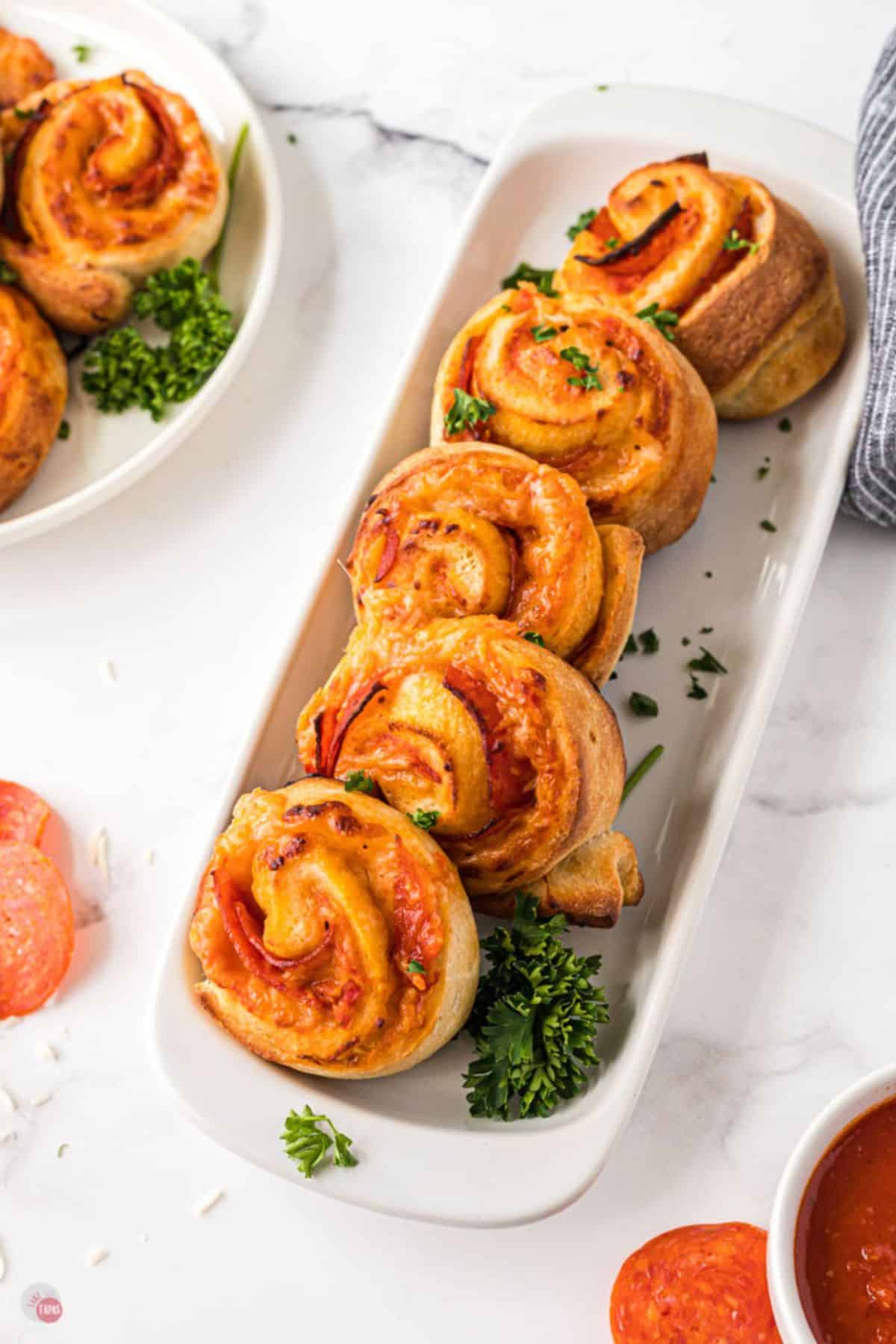 pizza pinwheels on a white plate