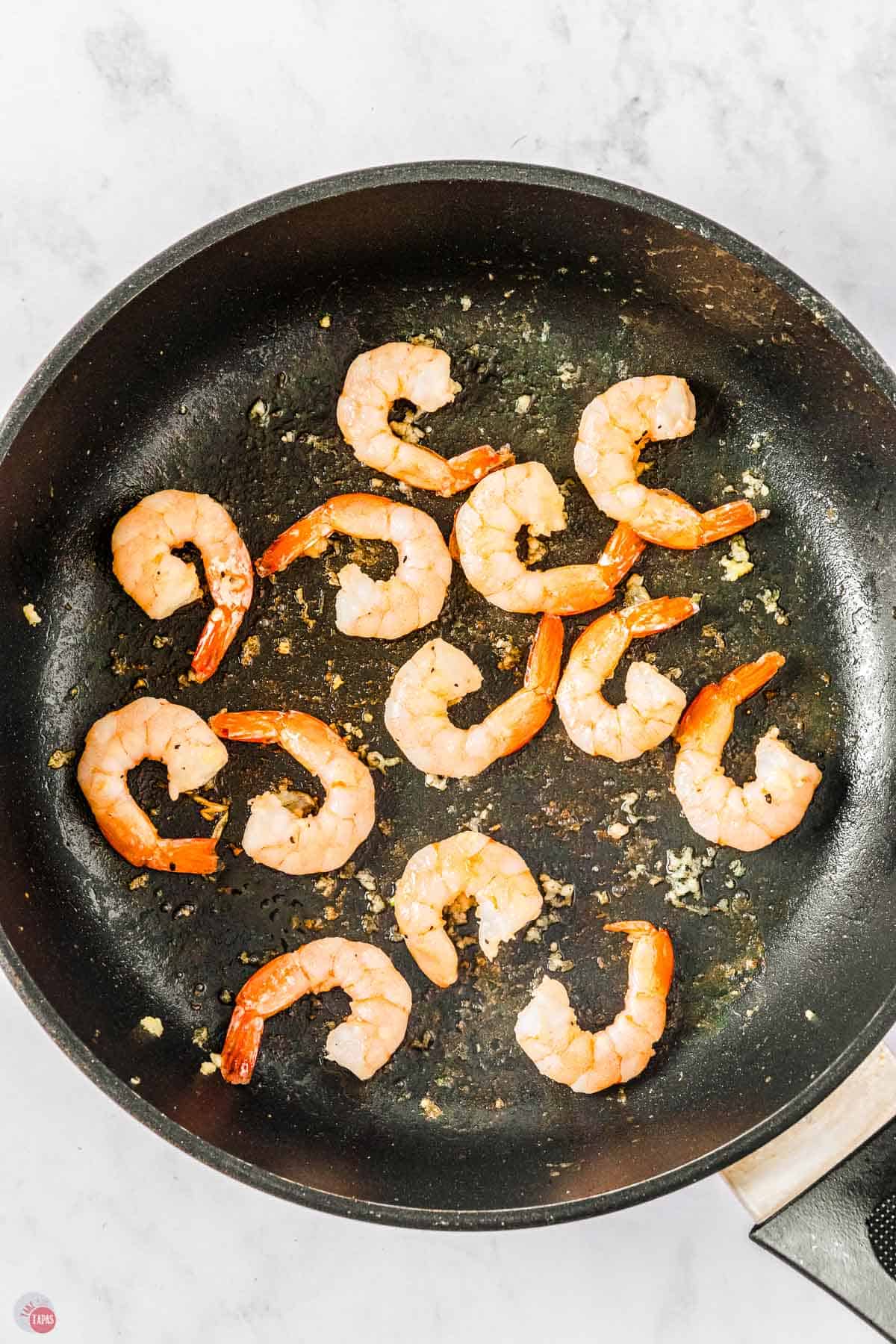 skillet with shrimp cooking