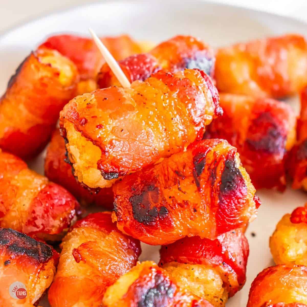 bacon wrapped tater tots on a plate