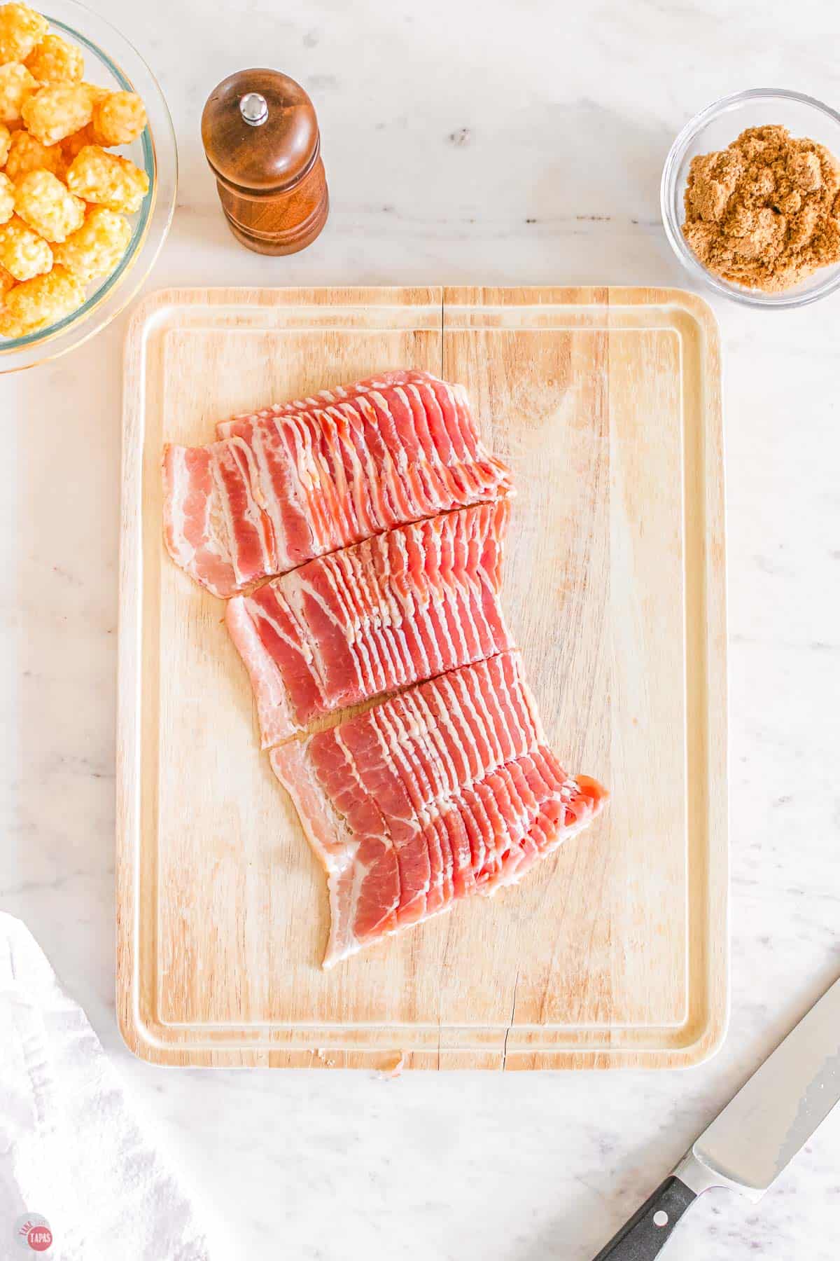 slices of bacon on a cutting board cut into smaller pieces